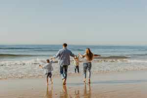 Famille heureuse au bord de mer grâce à l'aide aux vacances de la CAF